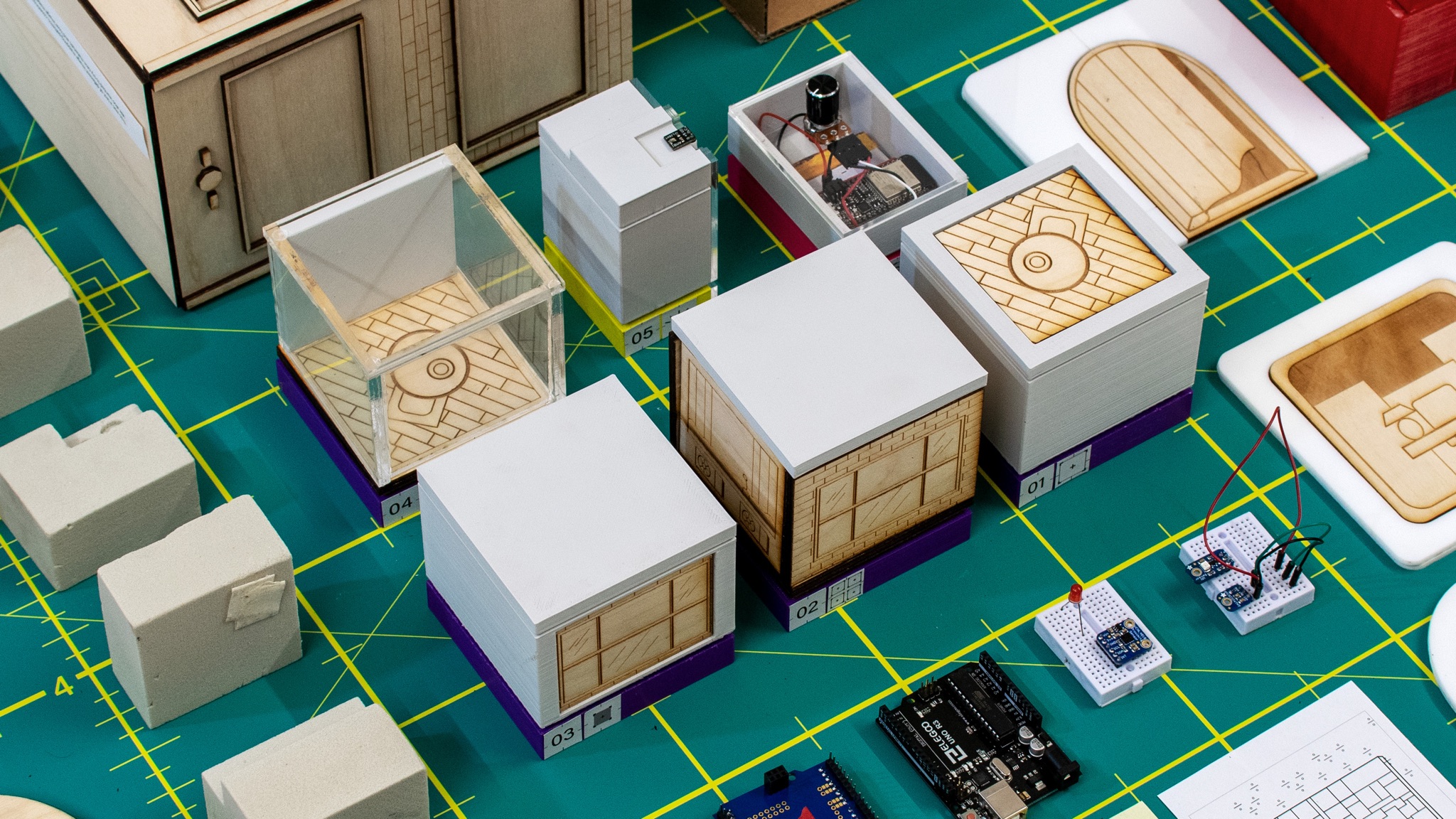 All six prototyping tools with Arduino components, breadboard, and image mapping materials spread on cutting mat