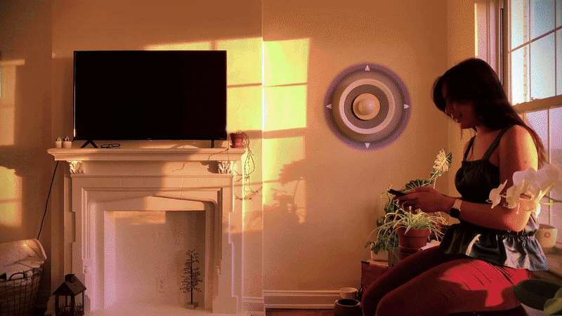 Orbit speaker glowing with abstract light patterns representing emotional states